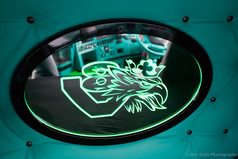 Ovaler beleuchteter Spiegel mit schwarzem Rahmen und grn leuchtendem Scania Greif Motiv, montiert im LKW.