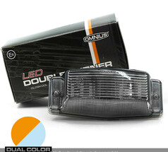 Omnius LED Doppelbrenner mit Rauchglas und Verpackung. Ein Kreis zeigt die umschaltbare orange und weie Beleuchtung.