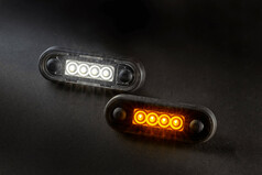 LED-Begrenzungsleuchten mit schwarzem Gehuse, eine leuchtet wei, die andere gelb.