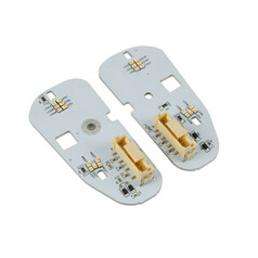 Zwei graue Platinen des Tagfahrlicht-Umbausatzes mit bernsteinfarbenen LEDs und beigen Steckverbindern.